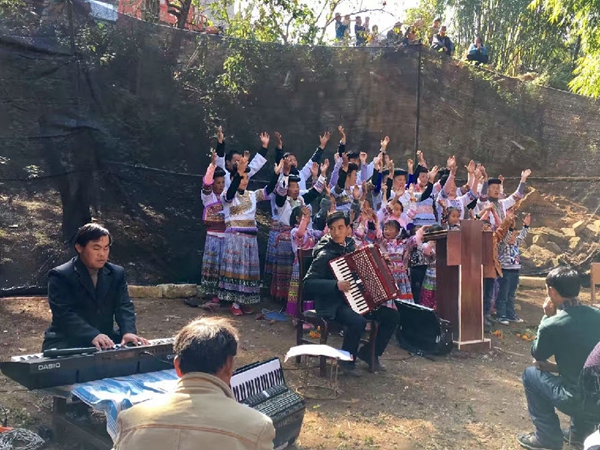 The choir sings hymns to praise God and some brothers play instruments The Miao choir sings hymns to praise God and some brothers play instruments